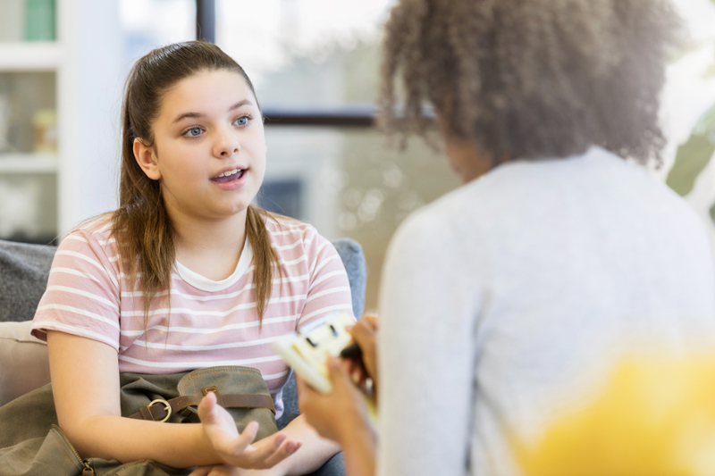 young woman speaking with health care provider